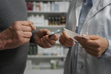 senior-man-consulting-female-pharmacist-medication